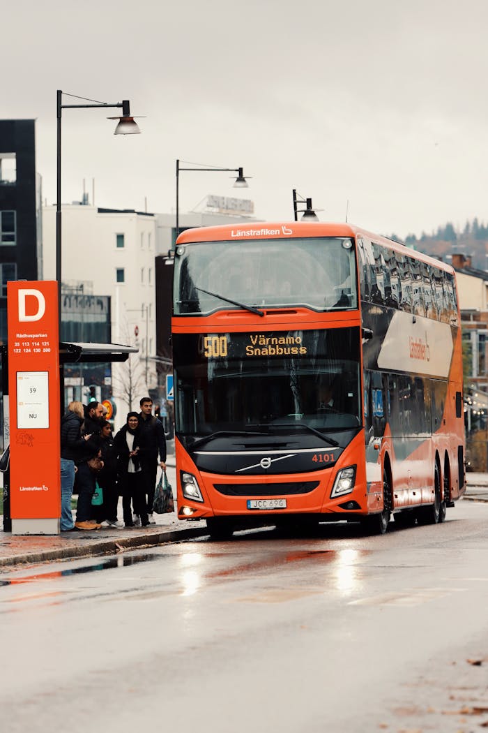 Double decker bus at a city stop in Jönköping, Sweden, during a rainy day.